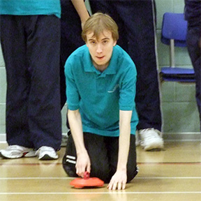 Oliver prepares to deliver a stone for his team